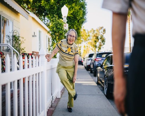 elderly couple walking happily in a sunny park